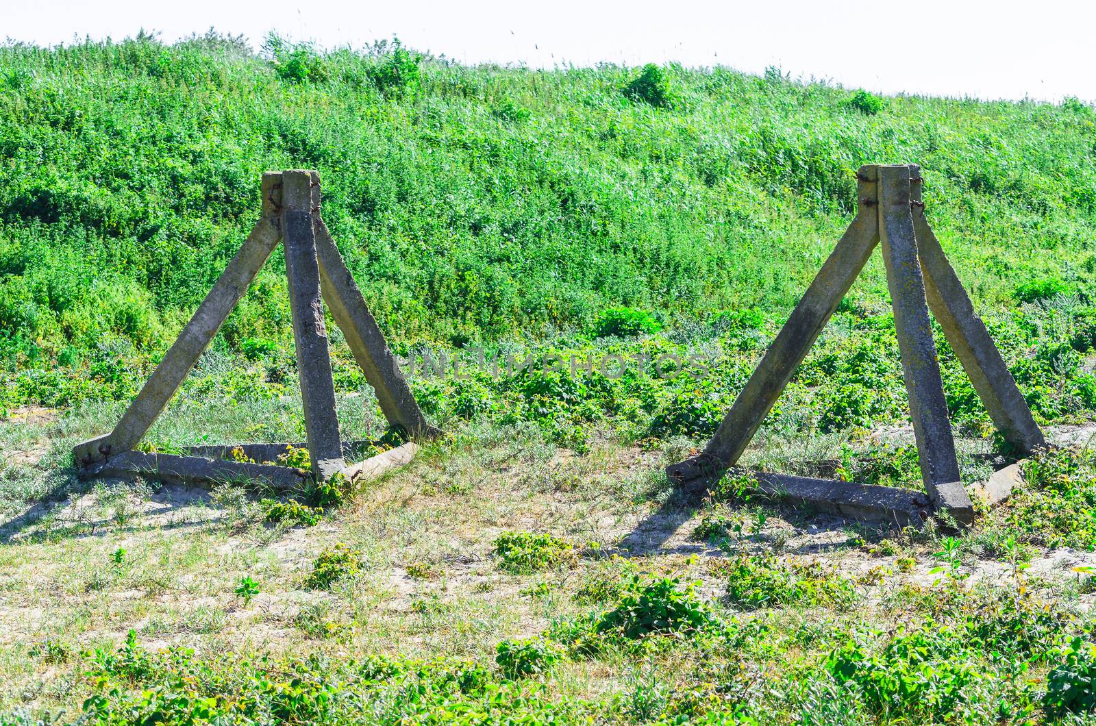 Real concrete tank barriers on the beach. Also called Czech hedgehogs. From the period of World War II on a beach at the Western Wall.