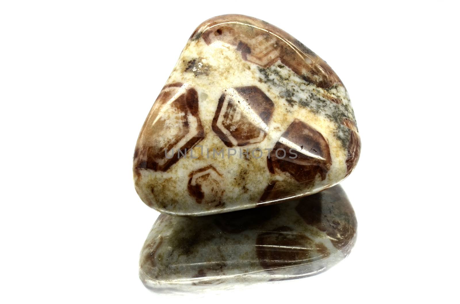 Sample of a beautiful tumbled Limestone Garnet semiprecious stones isolated on white