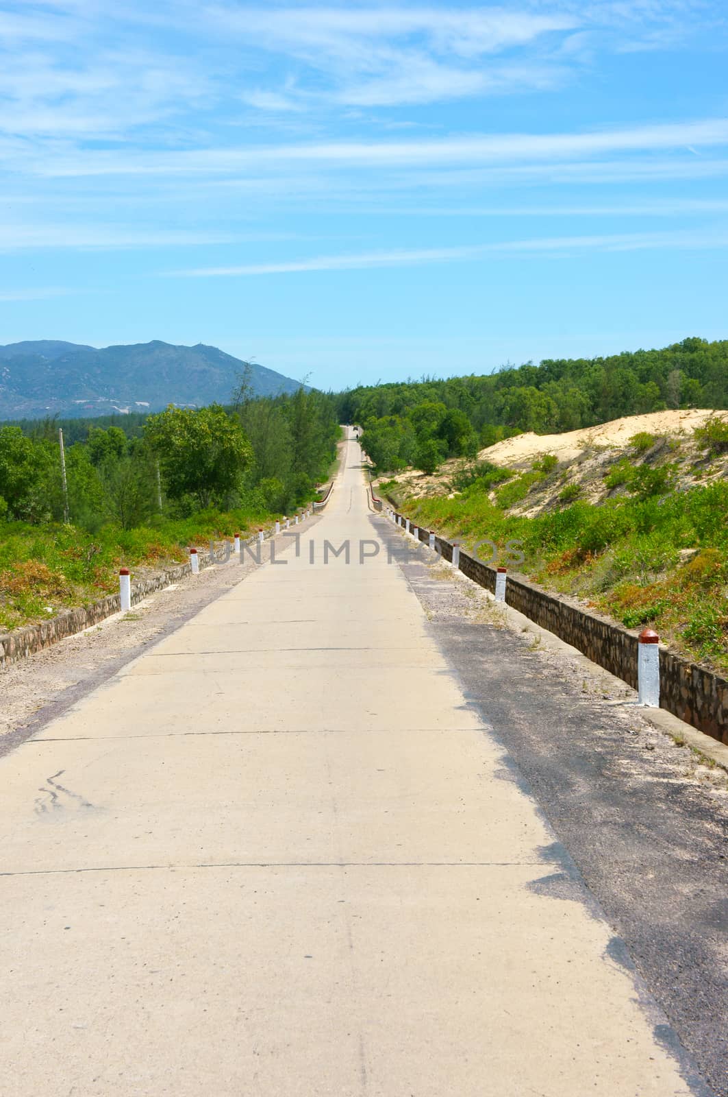 Vietnamese highway, cross sand hill, jungle, countryside or mountain, route for travel, discovery Vietanam, landscape of rural under blue sky on day