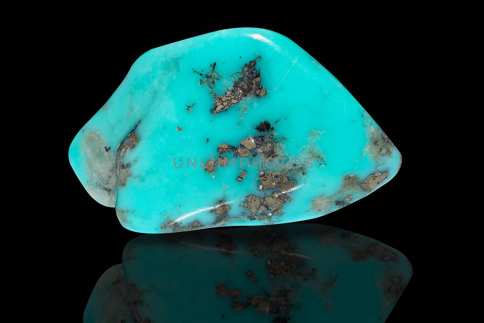 Sample of a beautiful Turquoise tumbled stone specimen isolated on black background