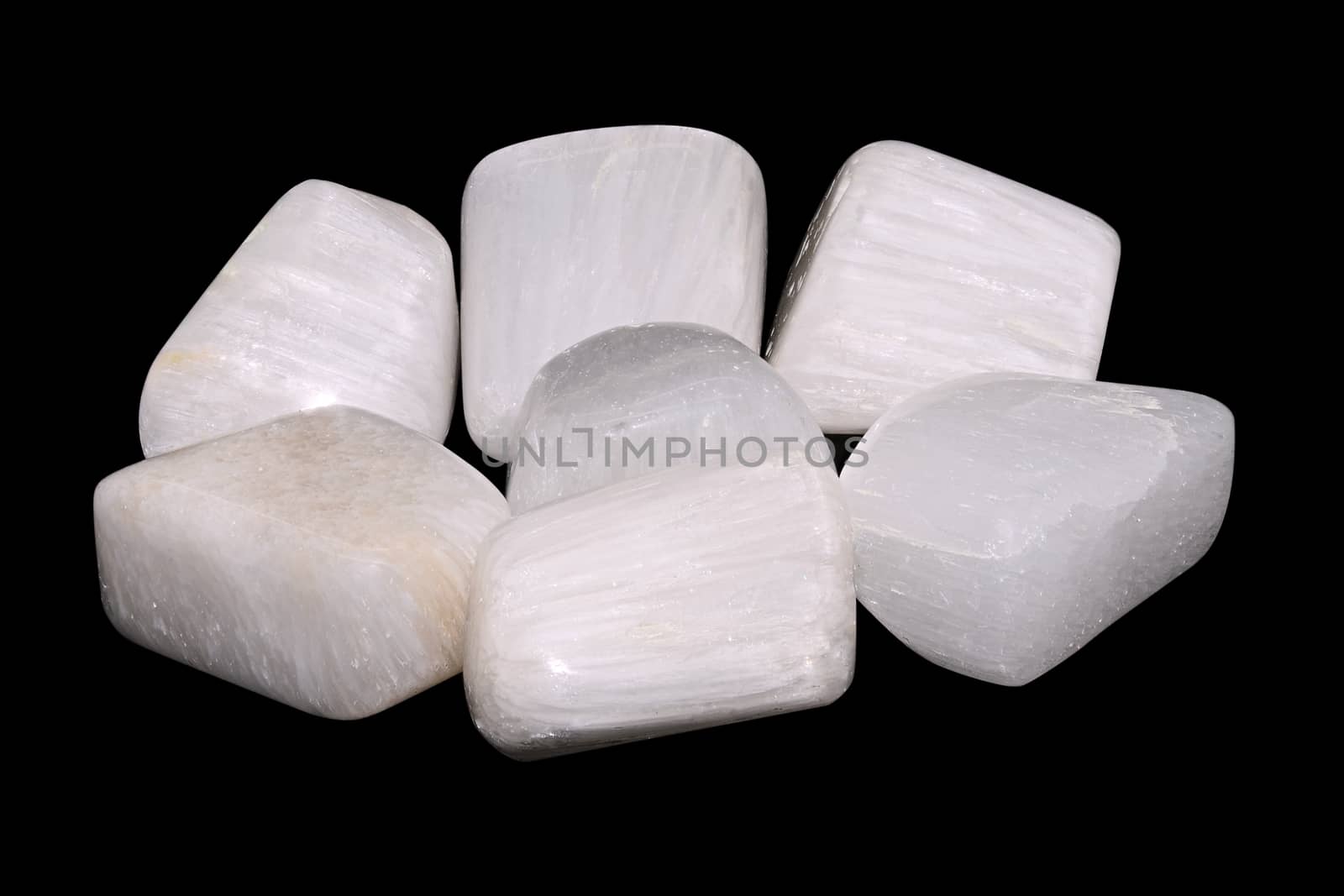 Set of a beautiful Scolecite tumbled semiprecious stones isolated on black background