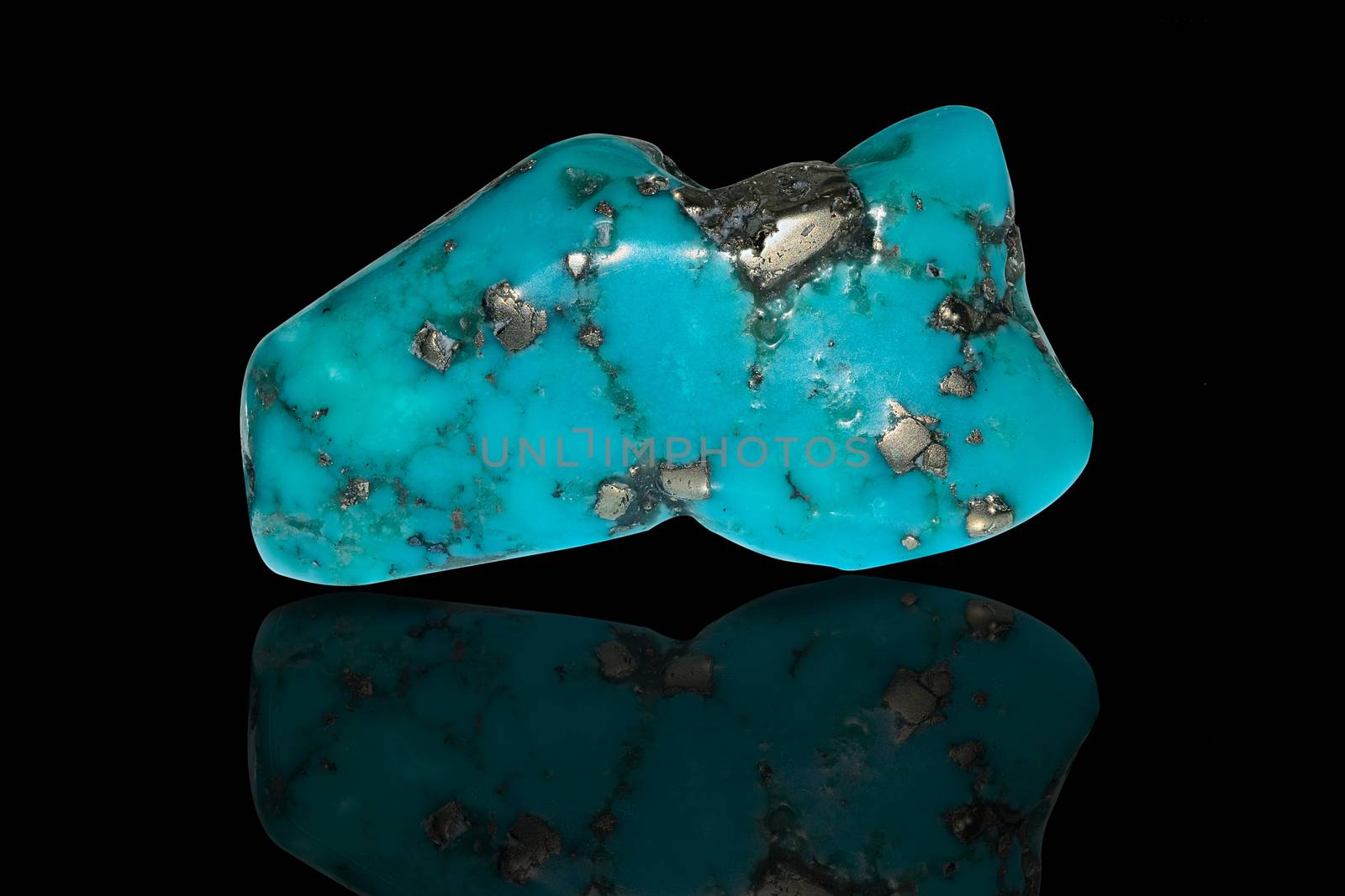 Sample of a beautiful Turquoise tumbled stone specimen isolated on black background
