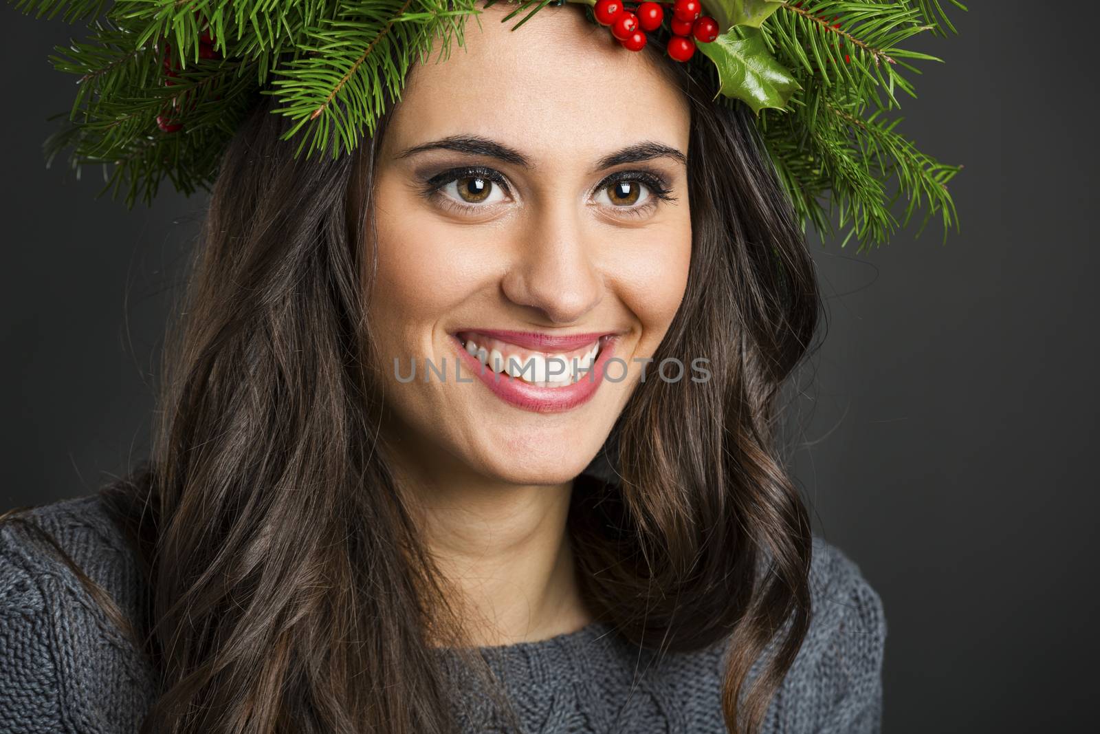 Portrait of a beautiful woman with Cristmas decorations on the head
