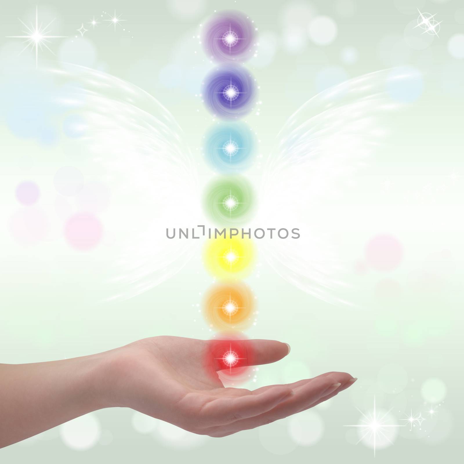 Healing Hand and seven chakras on a sparkling pastel coloured background