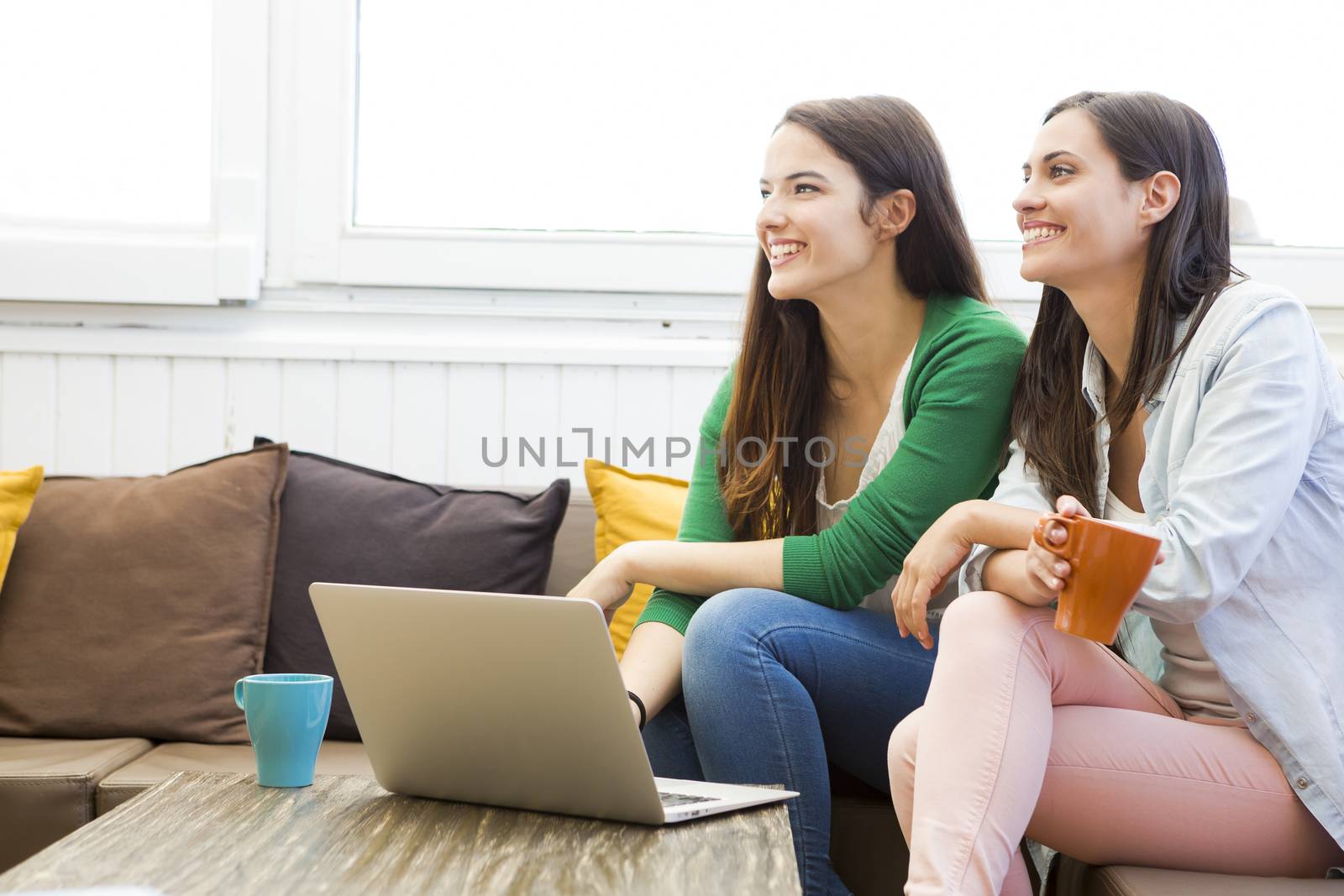 Female friends at the local coffee shop drinking coffee and working