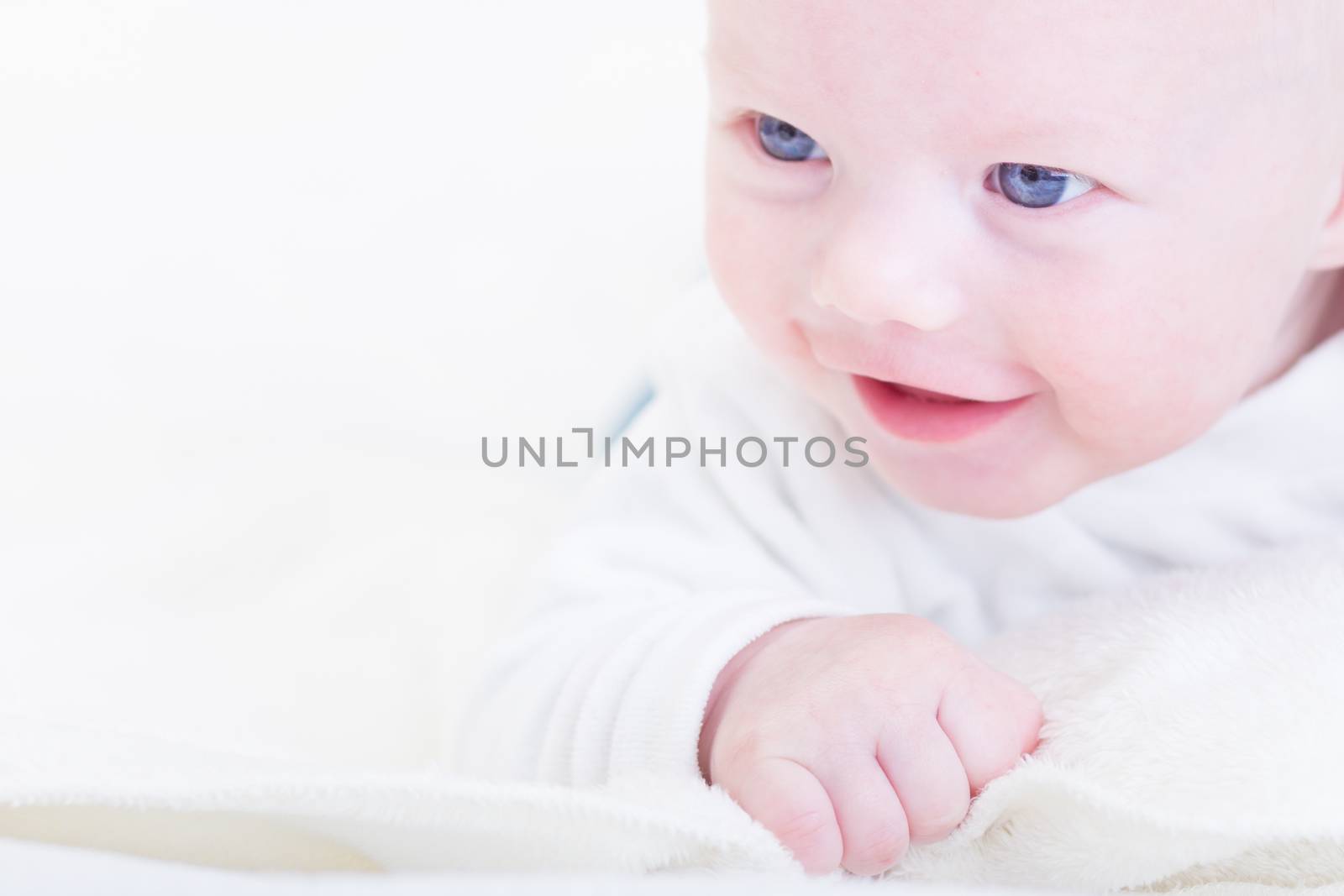 Cute blonde little baby boy with blue eyes.