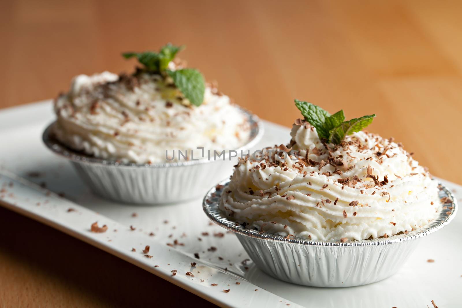 Parfait desserts with fresh whipped cream and chocolate shavings. Shallow depth of field.