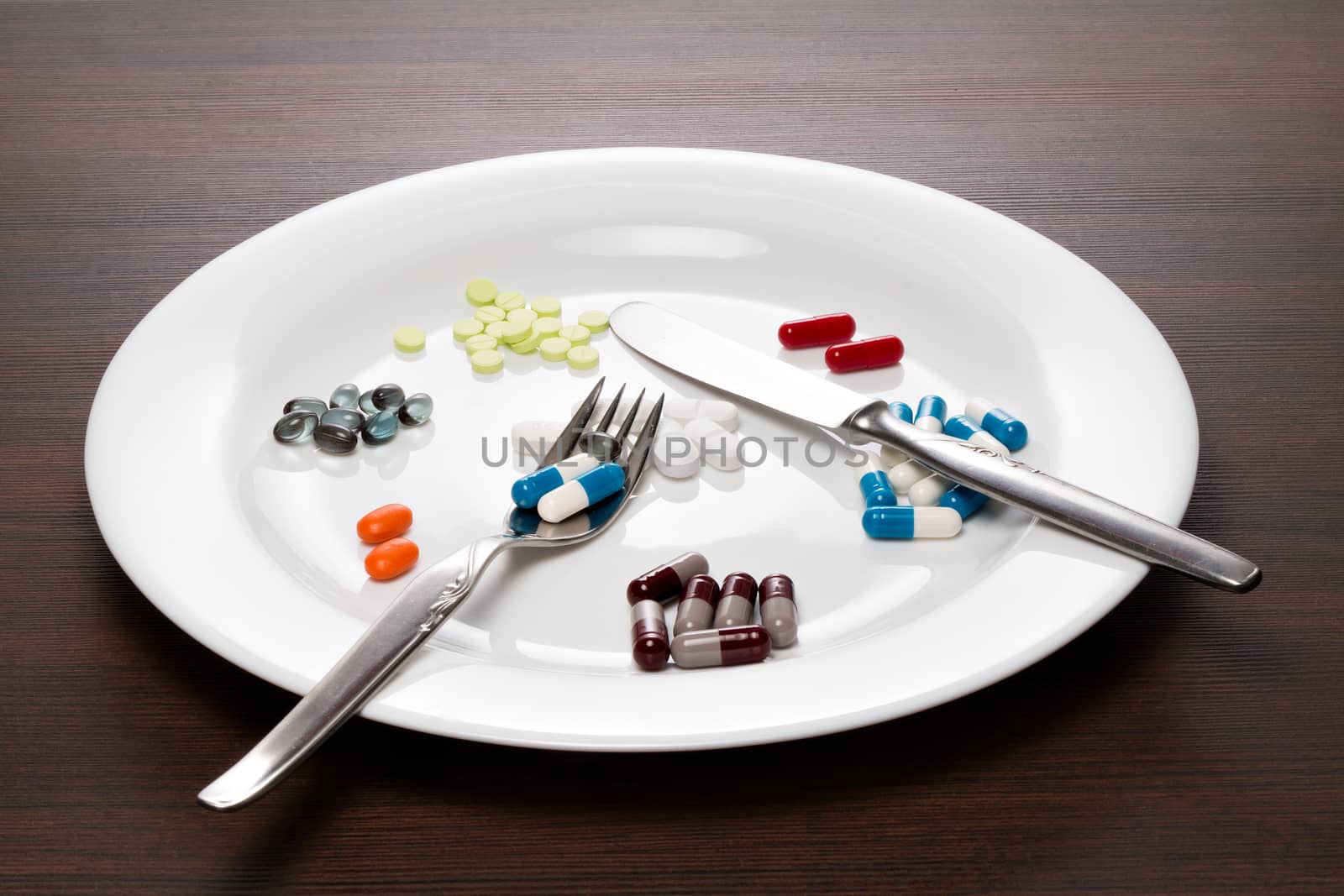 Tablets served on a white plate with knife and fork