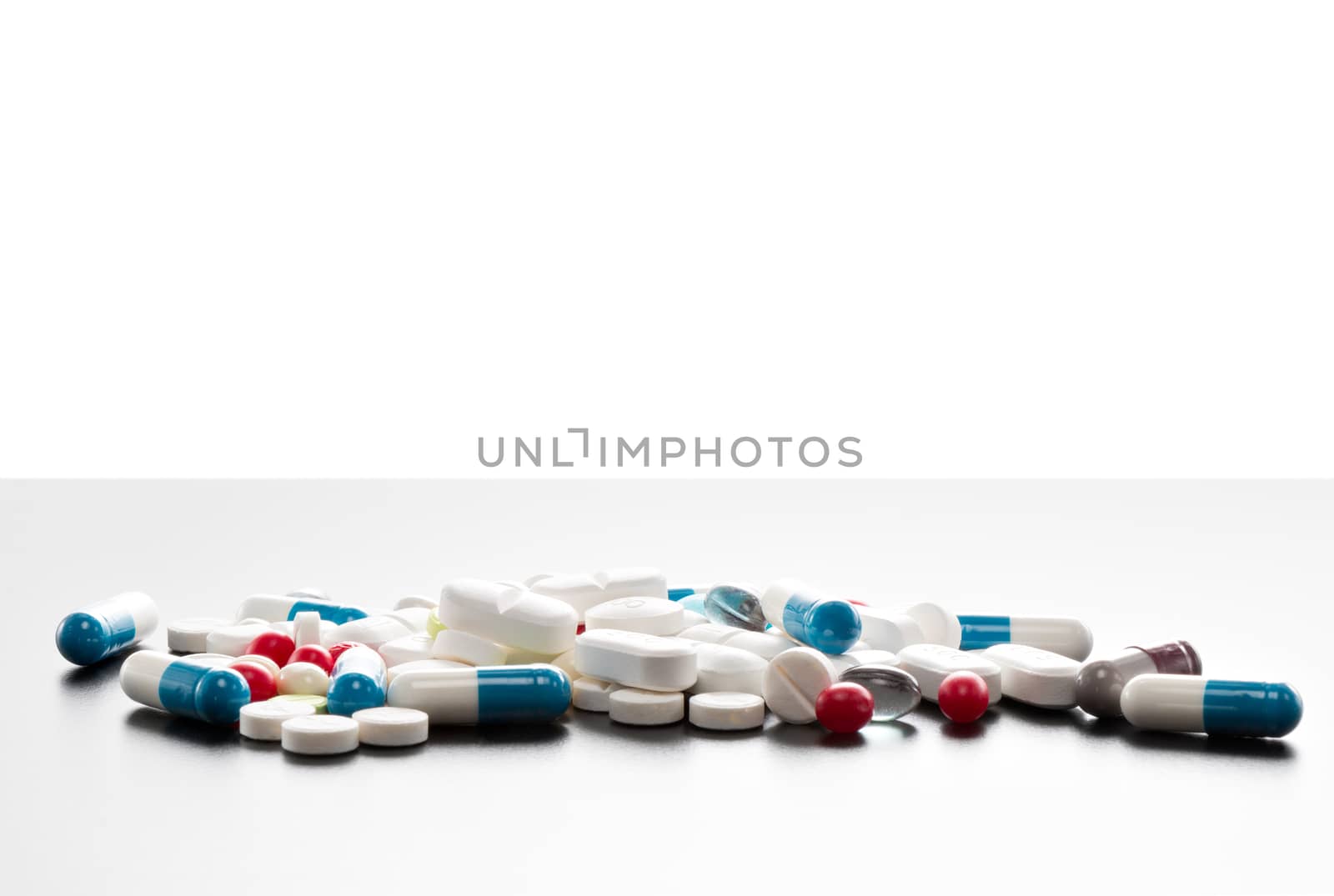 Many colorful tablets on a table, isolated