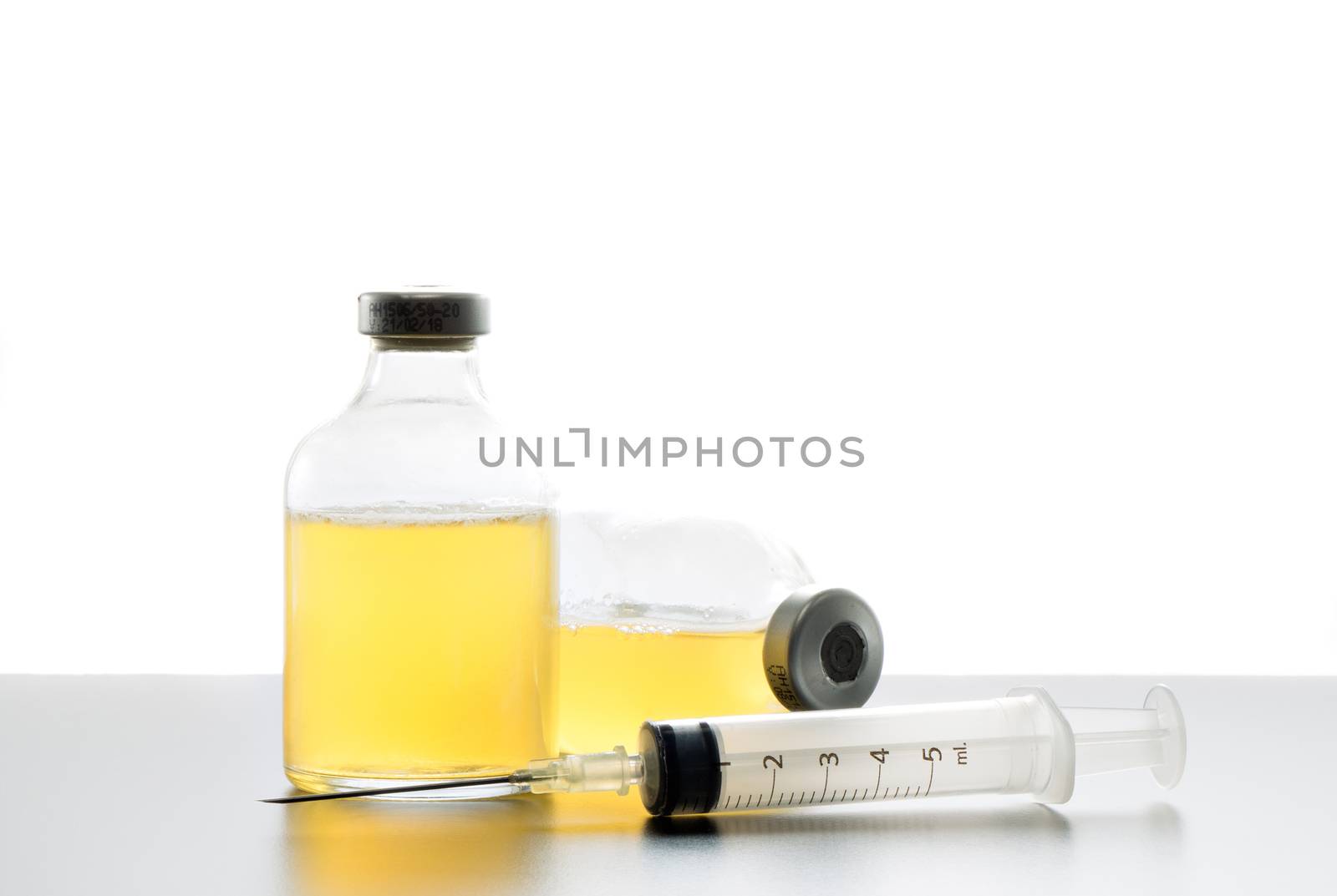 Syringe and ampules time on a table, isolated