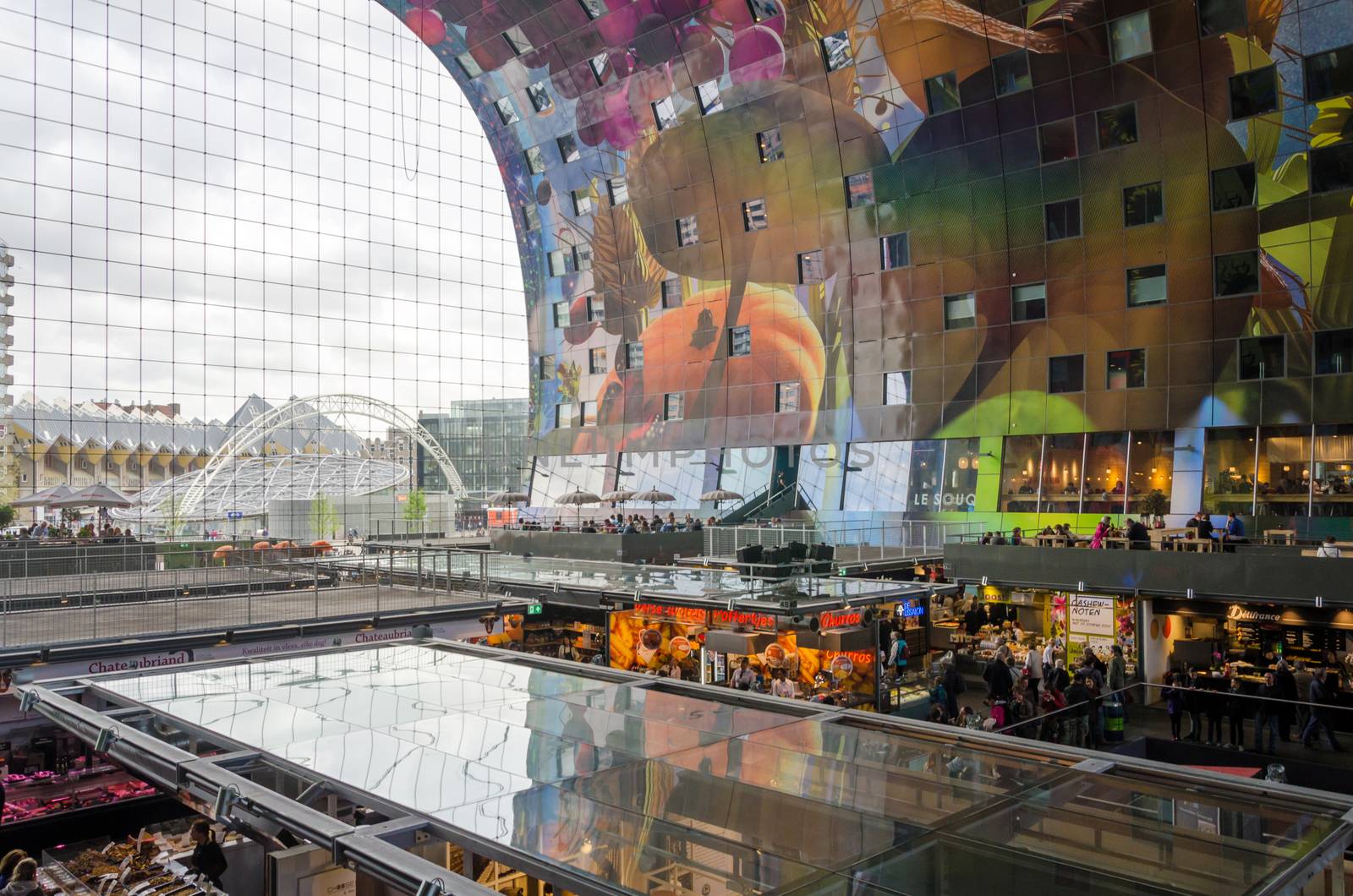 Rotterdam, Netherlands - May 9, 2015: People shopping in Markthal (Market hall) a new icon in Rotterdam. The covered food market and housing development shaped like a giant arch by Dutch architects MVRDV.