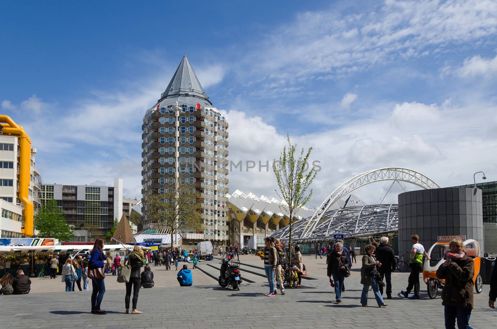 Rotterdam, Netherlands - May 9, 2015: People around Pencil tower, cube houses and Blaak Station in the center of the city on May 9, 2015, in Rotterdam, Blaak district, The Netherlands