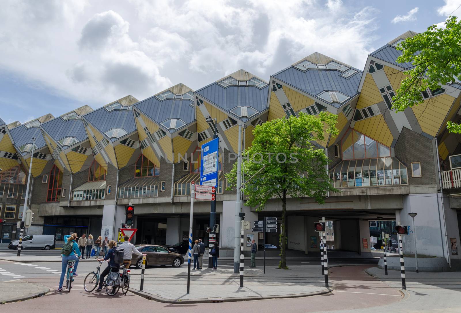 Rotterdam, Netherlands - May 9, 2015: Tourist visit Cube Houses the iconic in the center of the city. Cube Houses are a set of innovative houses built in Rotterdam and Helmond in the Netherlands, designed by architect Piet Blom.