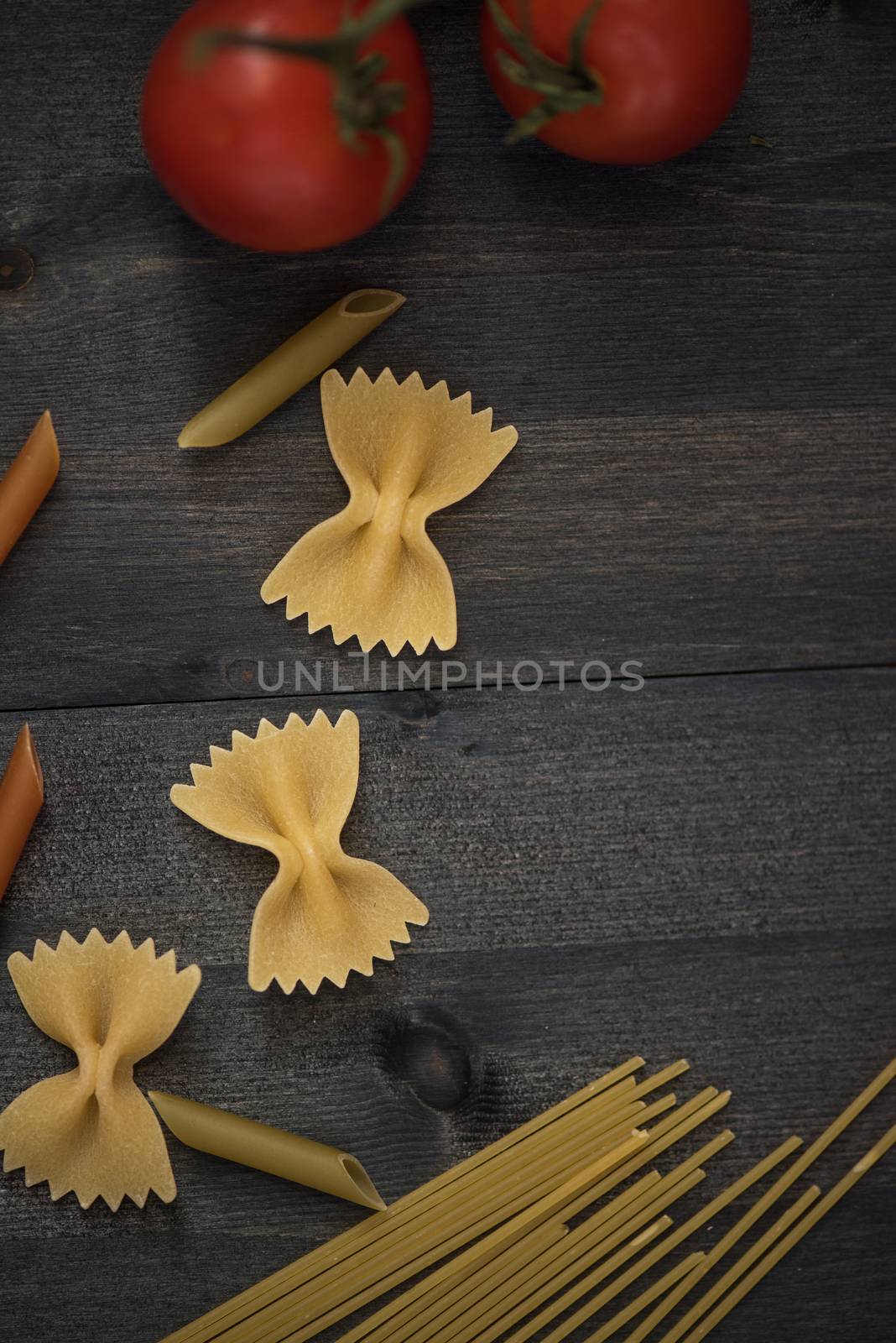 food background on rustic wood with pasta and tomatoes