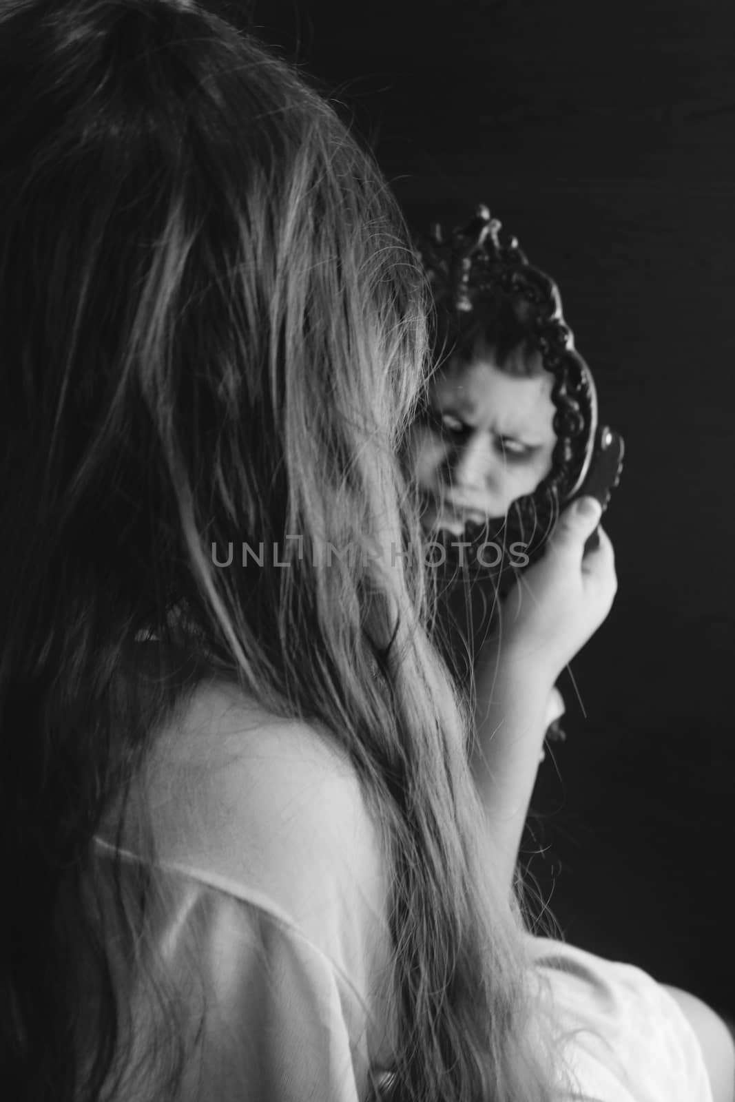 a girl staring at the mirror but her reflection is horrifying.