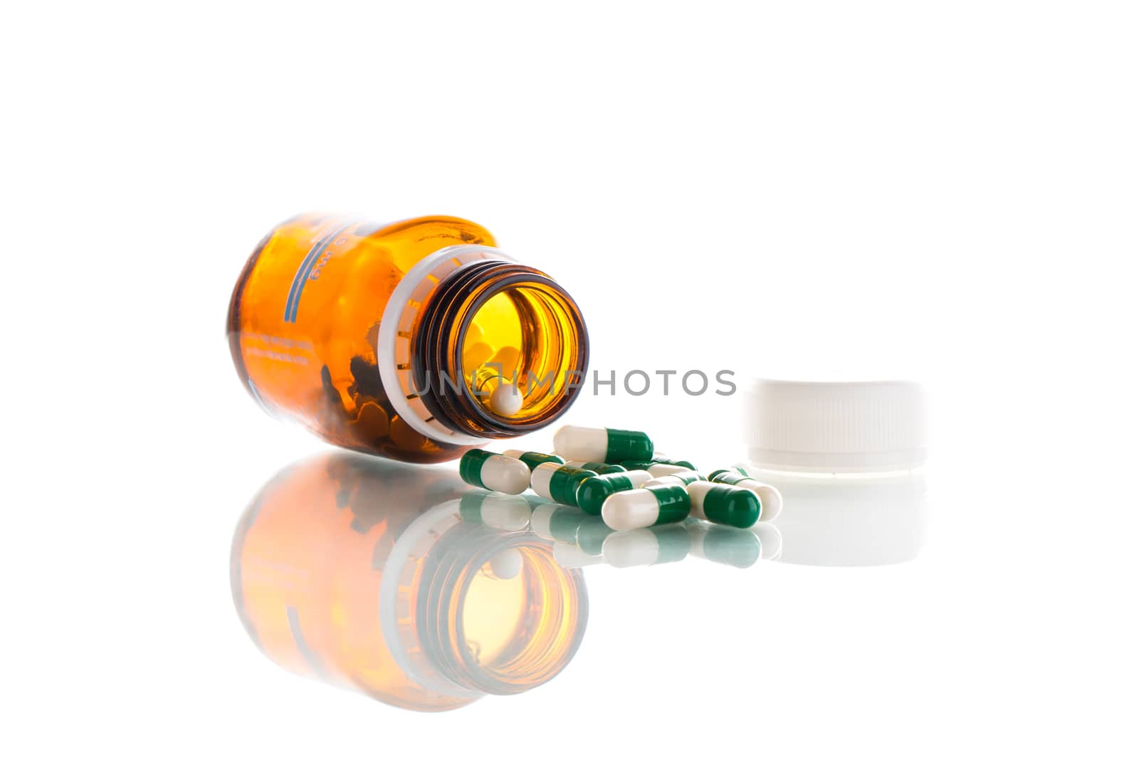 Big tablets with brown bottle on a white background