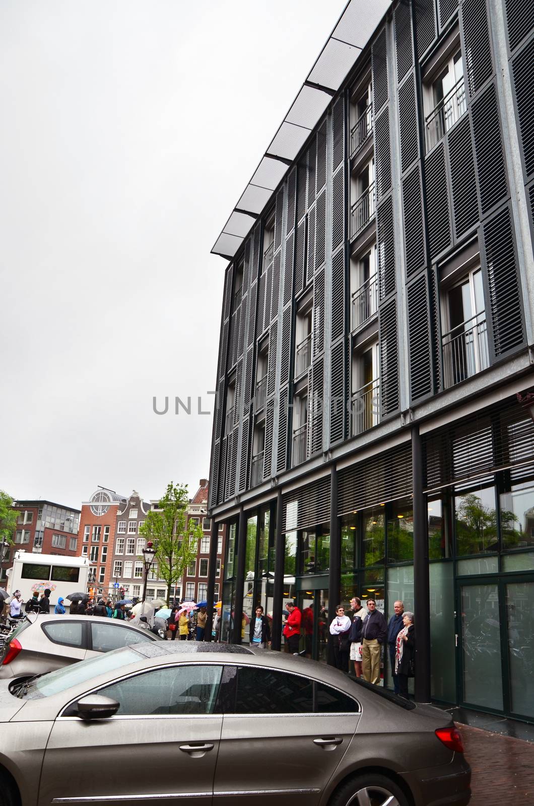 Amsterdam, Netherlands - May 16, 2015: Tourists stand in a queue to Anne Frank House Museum on May 16, 2015. The Anne Frank House Museum is one of Amsterdam's most popular museums opened in 1960.
