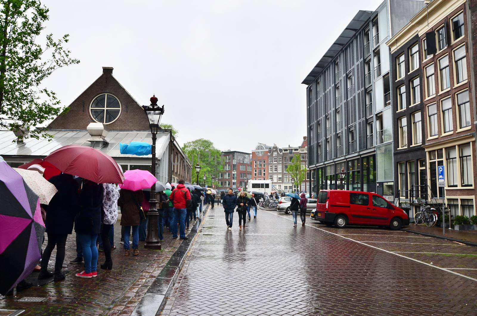 Amsterdam, Netherlands - May 16, 2015: People queuing at the Anne Frank house and holocaust museum in Amsterdam, Netherlands, on May 16, 2015. Anne Frank house is a popular tourist destination.