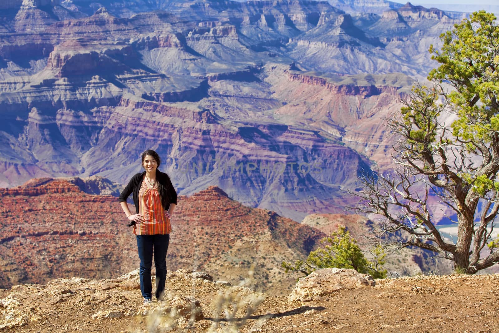 Beautiful biracial teen girl standing hand on hip  at the Grand Canyon, Arizona