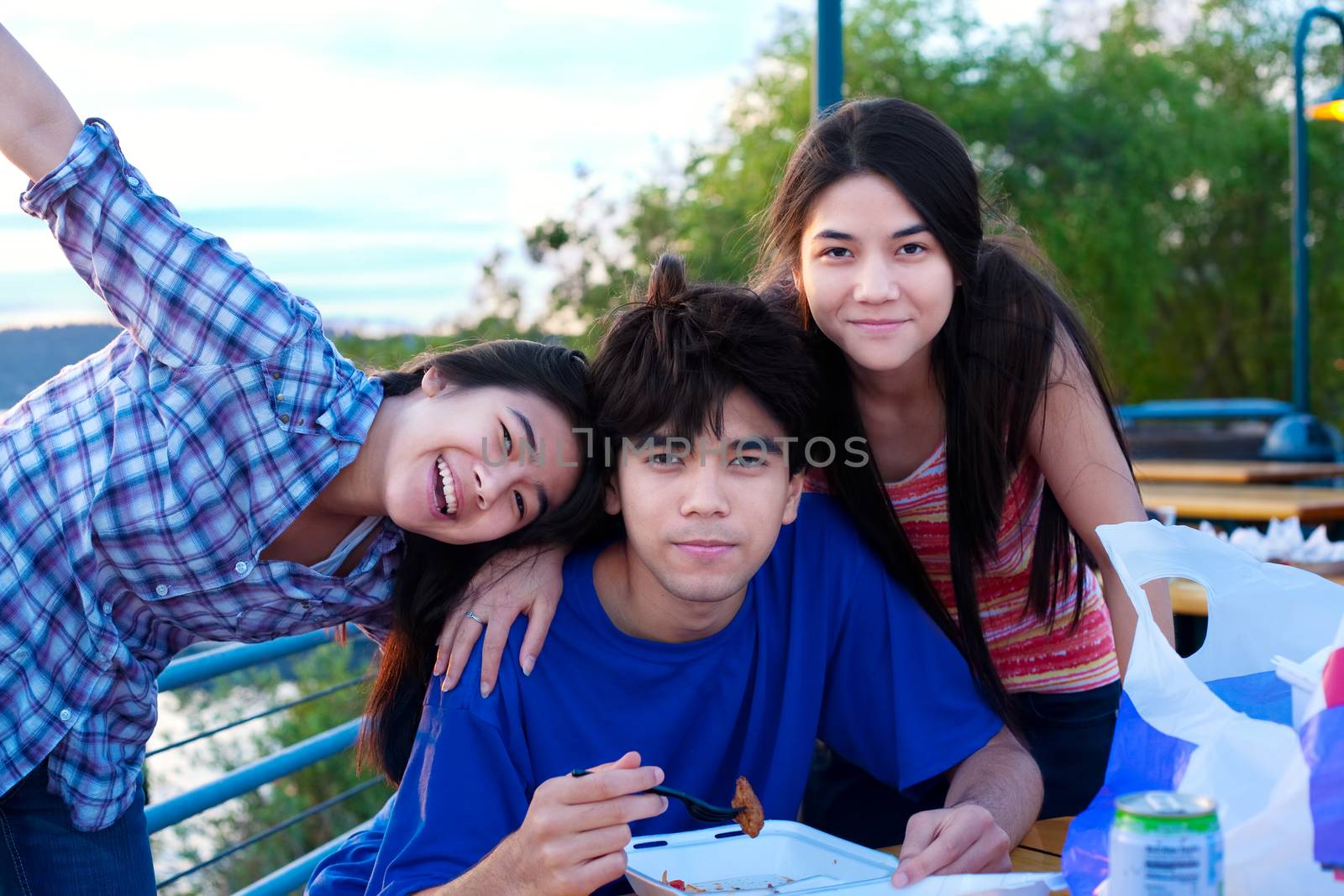 Brother and sisters outdoors, dining and hanging out by jarenwicklund