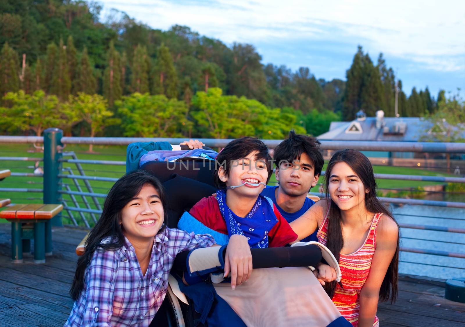 Brother and sisters outdoors,  hanging out at park with disabled by jarenwicklund