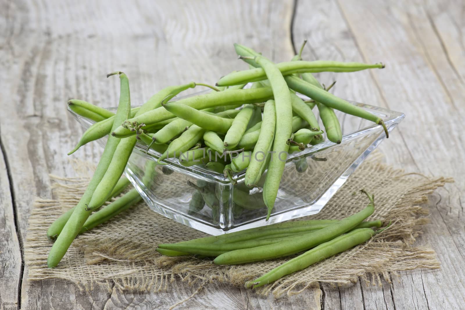 green beans on wooden background