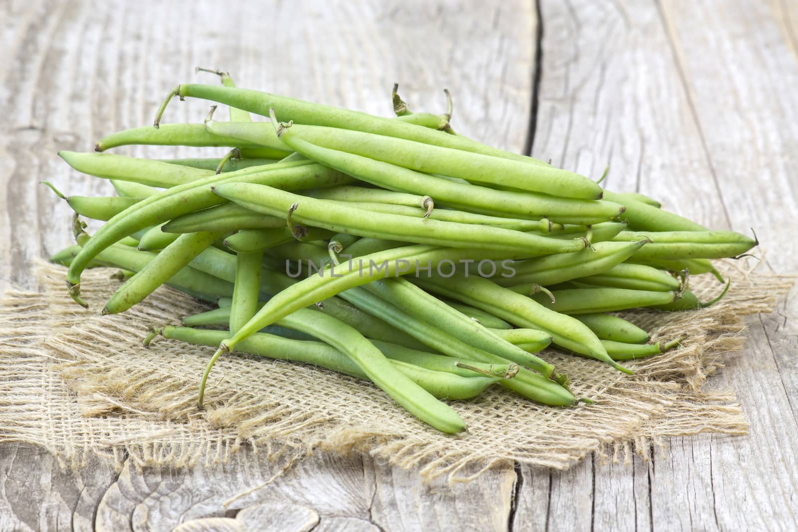 green beans on wooden background