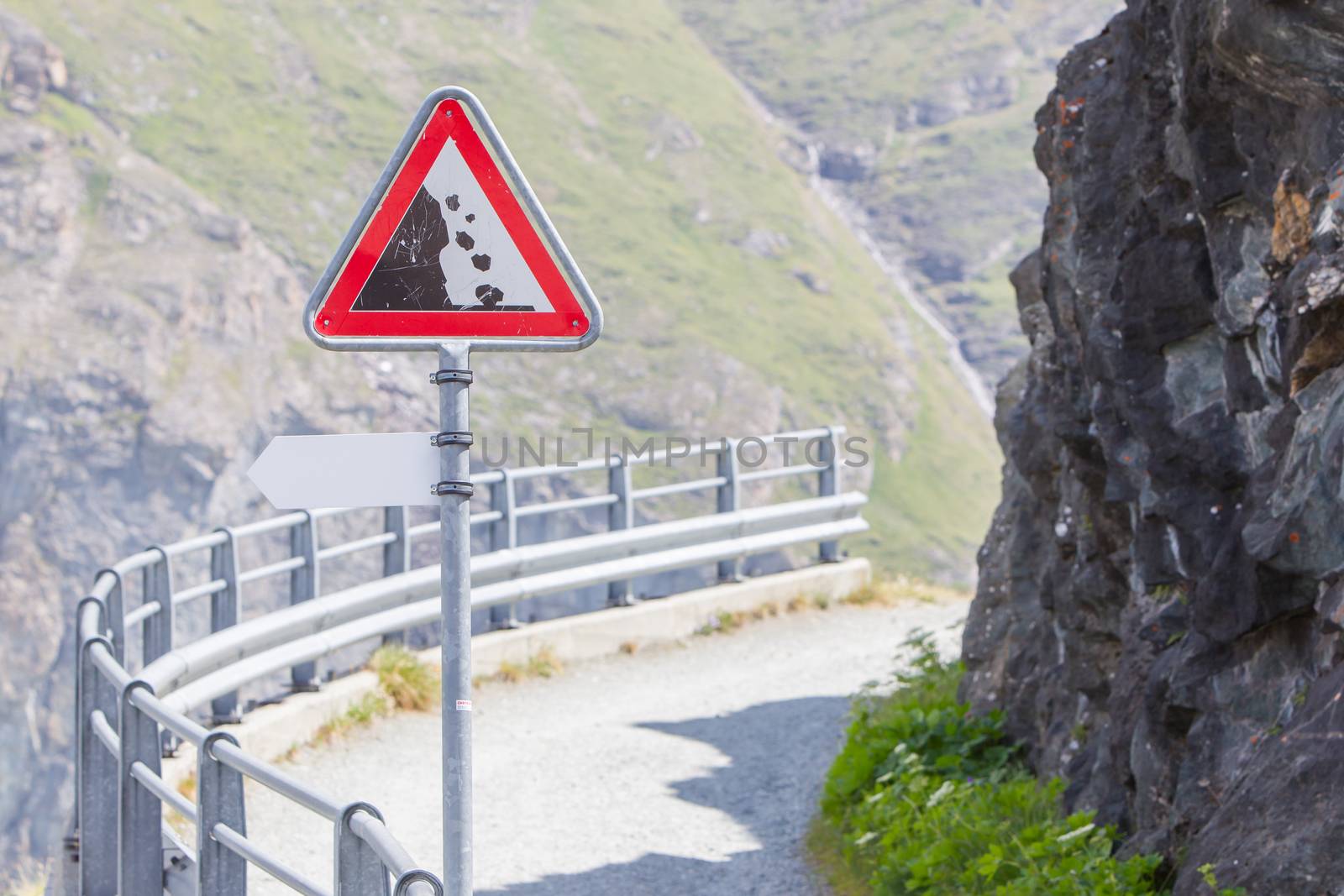 Warning stone fall road sign on mountain road, Switzerland