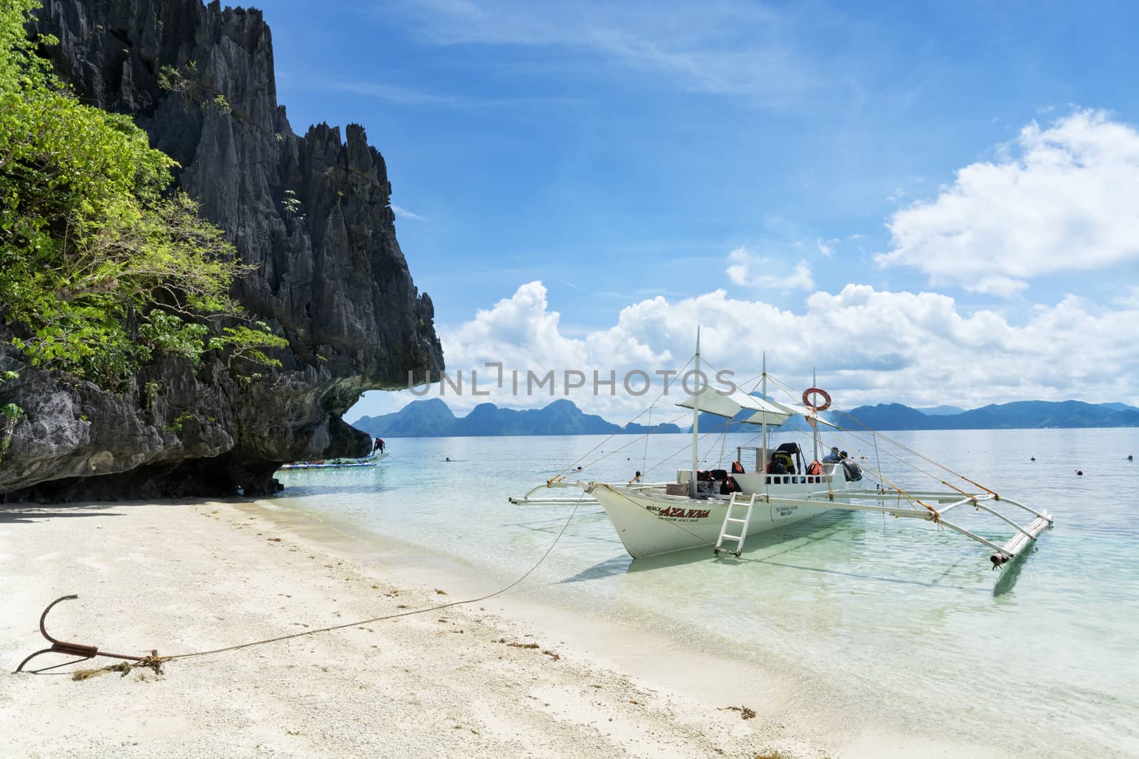  El Nido, Philippines  - May 22, 2014: Island hopping with traditional banca boat in El Nido , Palawan - Philippines . Island hopping is popular activity of tourists visiting Palawan. EL NIDO, PHILIPPINES - MAY 22, 2014: Island hopping with traditional banca boat in El Nido , Palawan on May 22.  Island hopping is popular activity of tourists visiting Palawan.