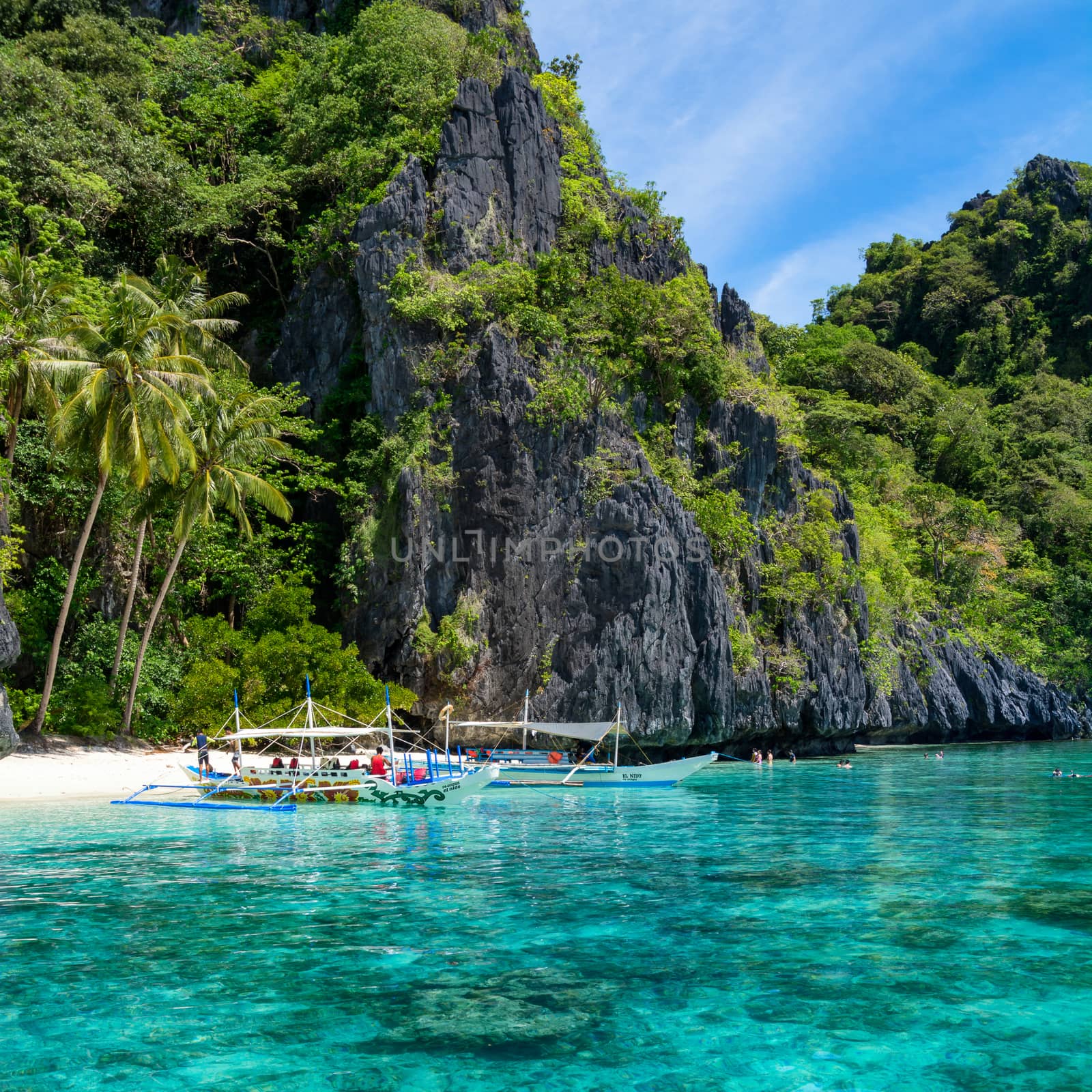  El Nido, Philippines  - May 22, 2014: Island hopping with traditional banca boat in El Nido , Palawan - Philippines . Island hopping is popular activity of tourists visiting Palawan. EL NIDO, PHILIPPINES - MAY 22, 2014: Island hopping with traditional banca boat in El Nido , Palawan on May 22.  Island hopping is popular activity of tourists visiting Palawan.