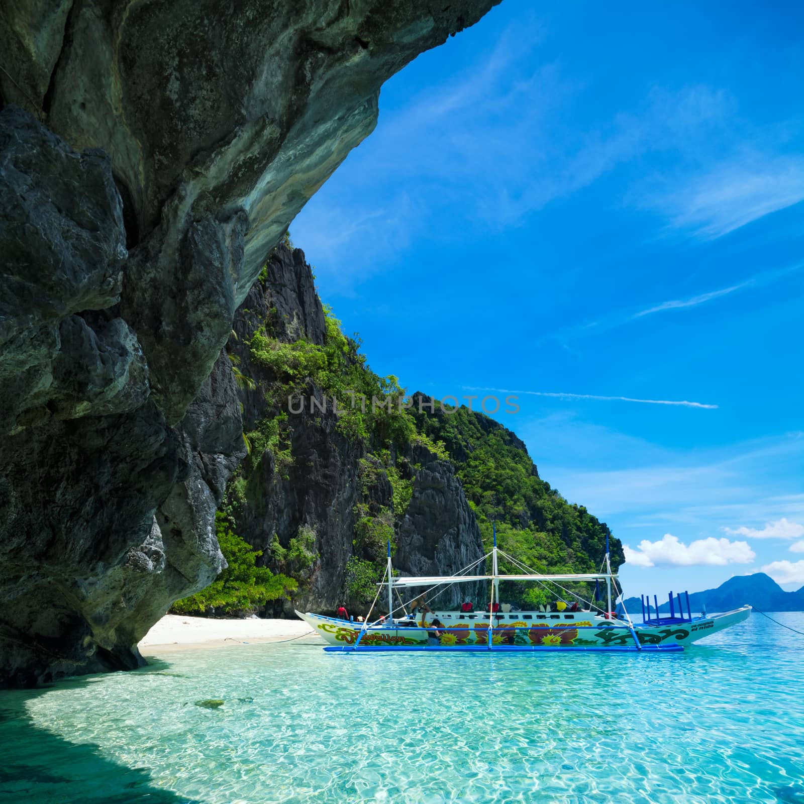  El Nido, Philippines  - May 22, 2014: Island hopping with traditional banca boat in El Nido , Palawan - Philippines . Island hopping is popular activity of tourists visiting Palawan. EL NIDO, PHILIPPINES - MAY 22, 2014: Island hopping with traditional banca boat in El Nido , Palawan on May 22.  Island hopping is popular activity of tourists visiting Palawan.