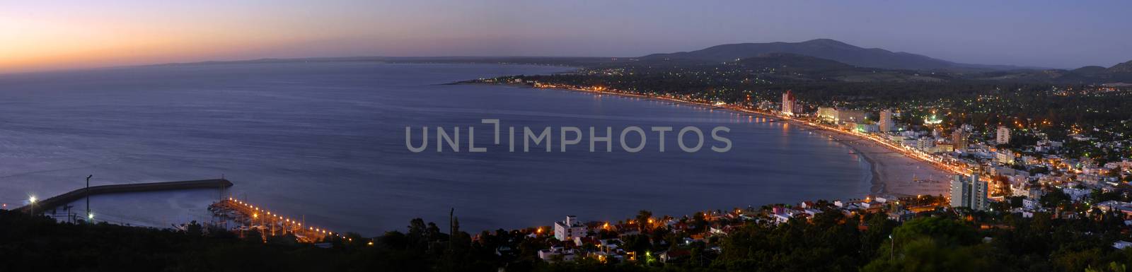 Summer beach panoramic cityscape with clear sunset and seashore aerial view. Piriapolis, Uruguay.