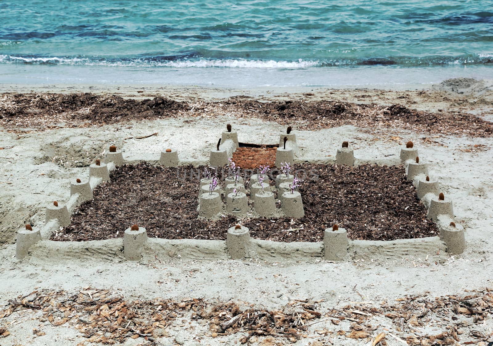 Big sand castle built on shore