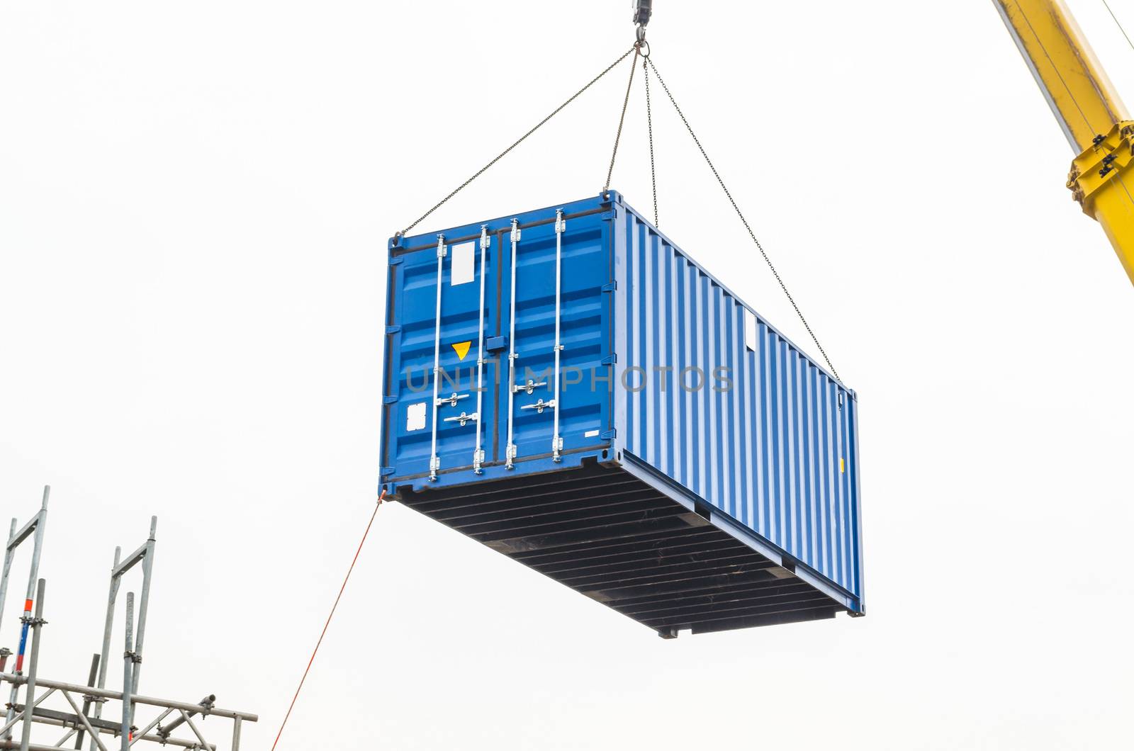 Blue building containers, cargo containers, residential containers at a loading crane.