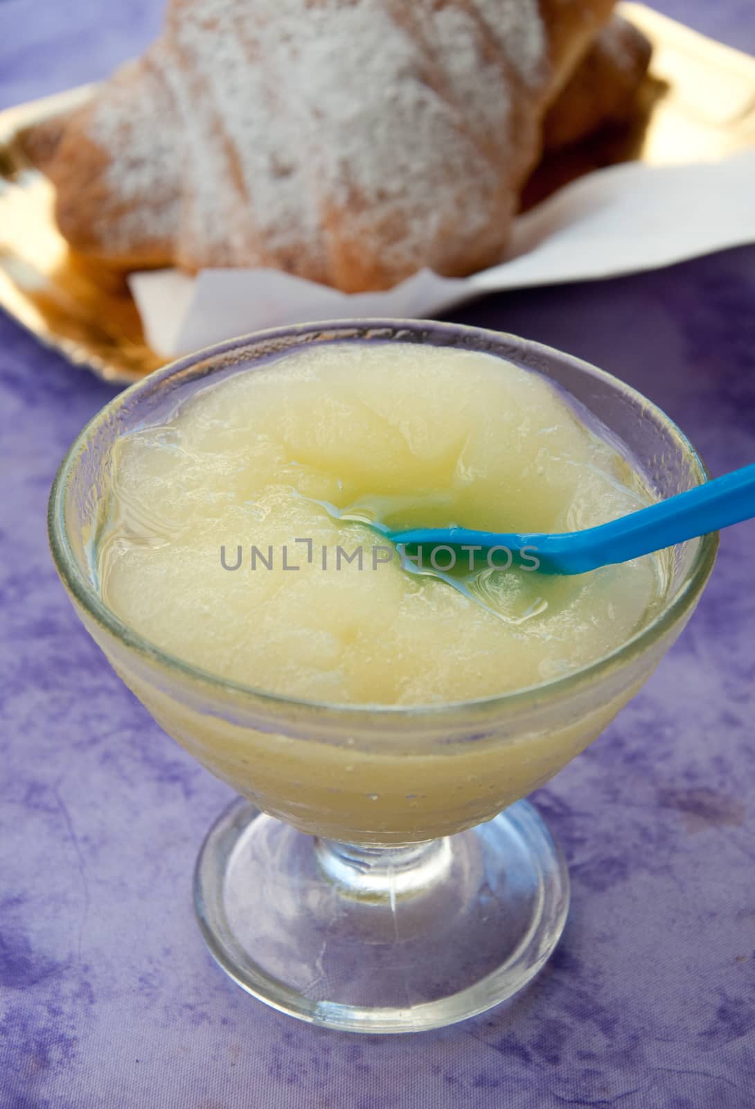 Typical breakfast of southern Italy with lemon granita and brioches