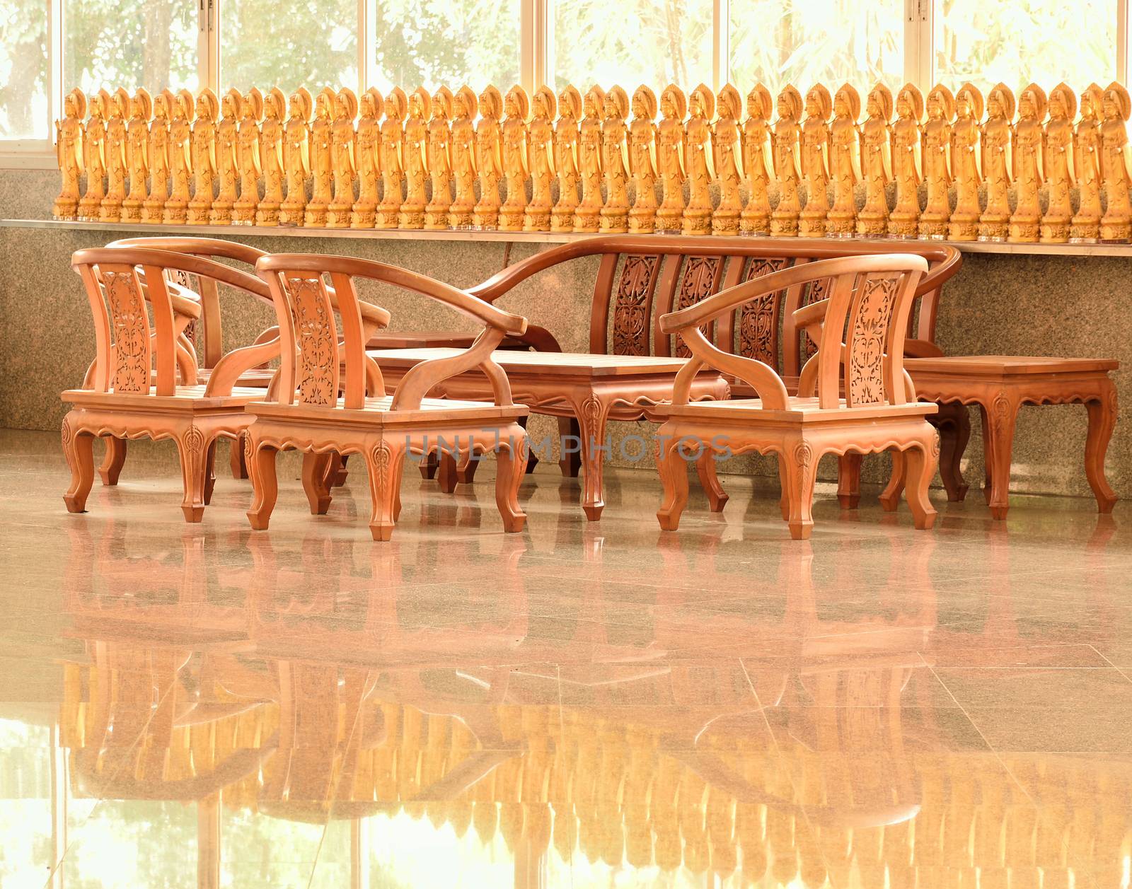 Capturing the group of tables, chairs, and goddess of mercy which this shot is captued at a corner in chinese tample of Thailand