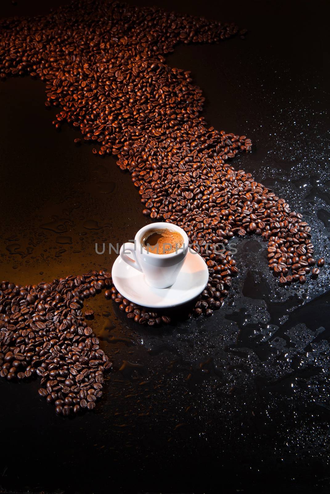 White cup of coffee standing on coffee beans