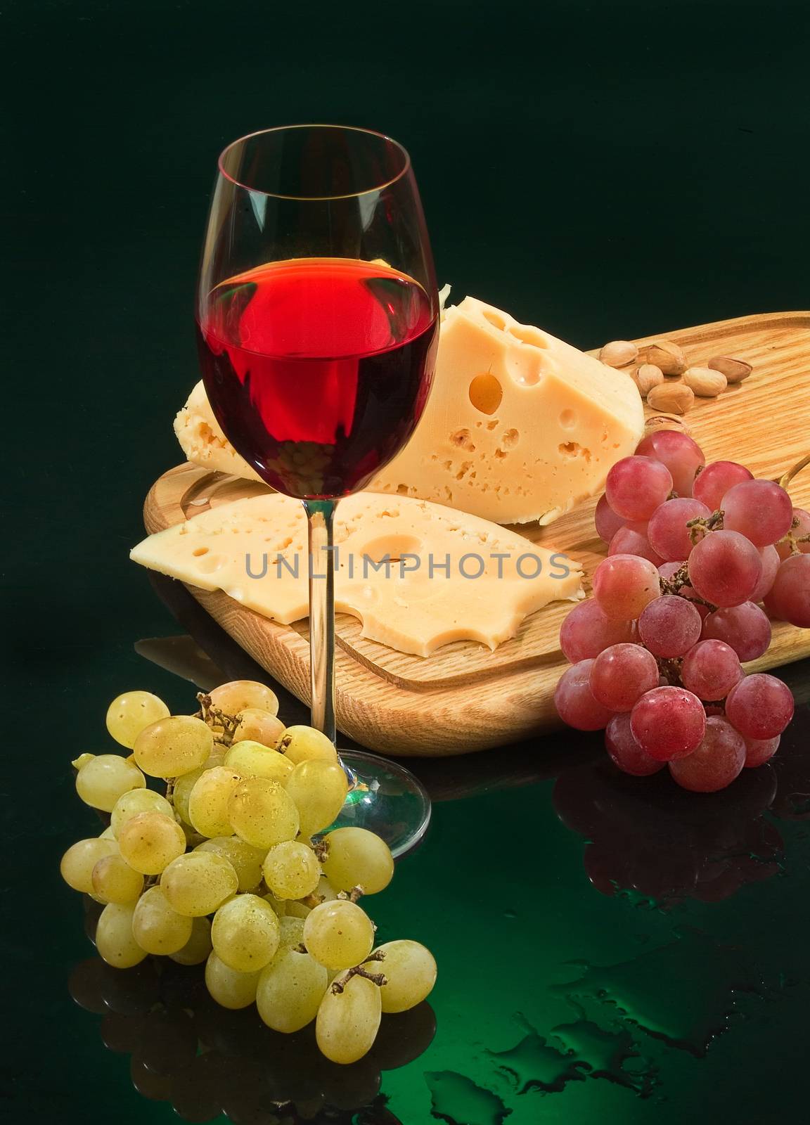 Still life with a glass of wine, grape and cheese