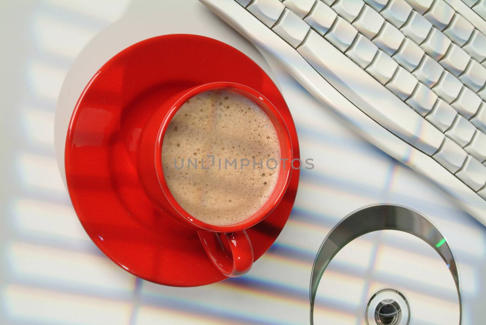 Cup of coffee and a part of computer keyboard