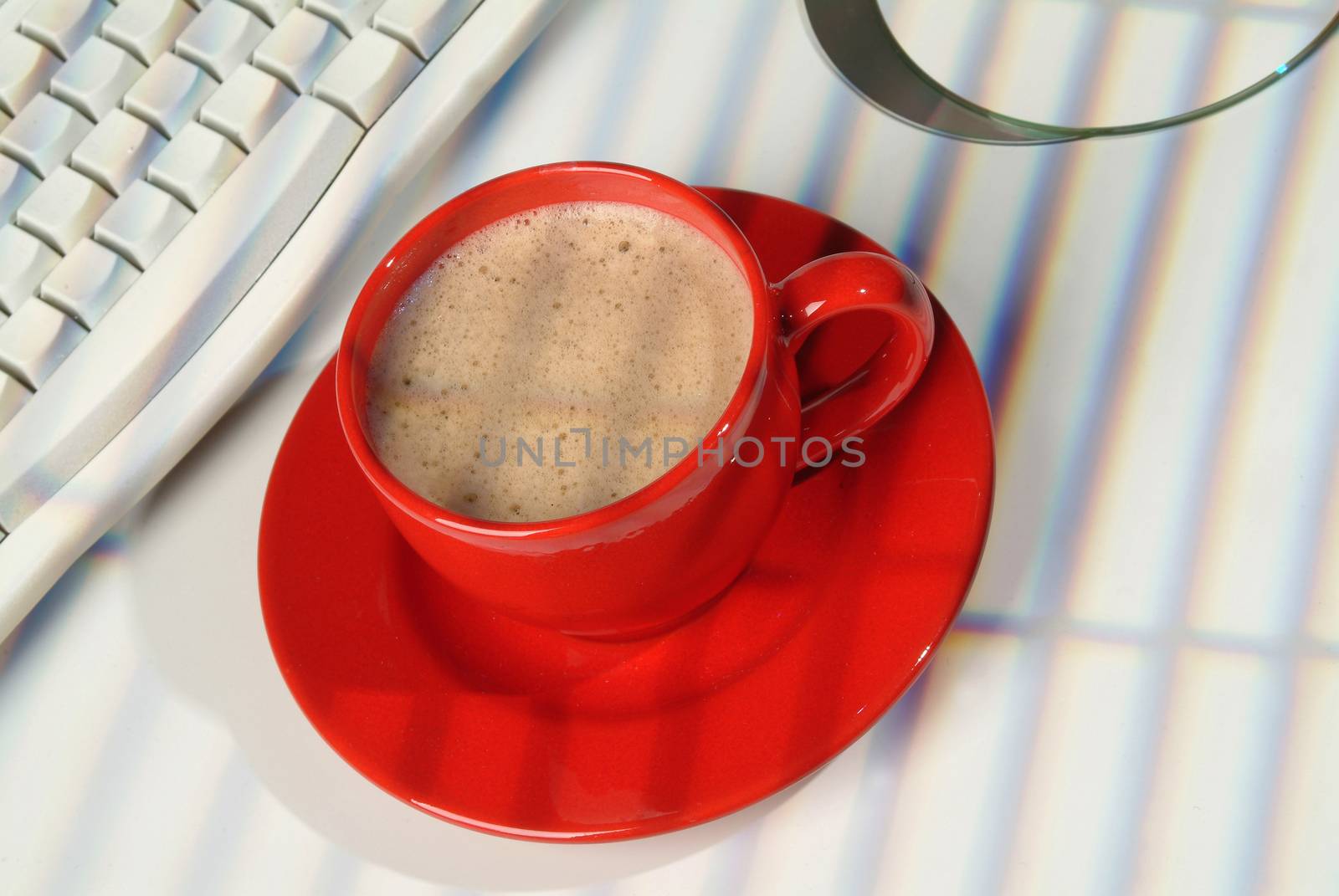 Cup of coffee and a part of computer keyboard