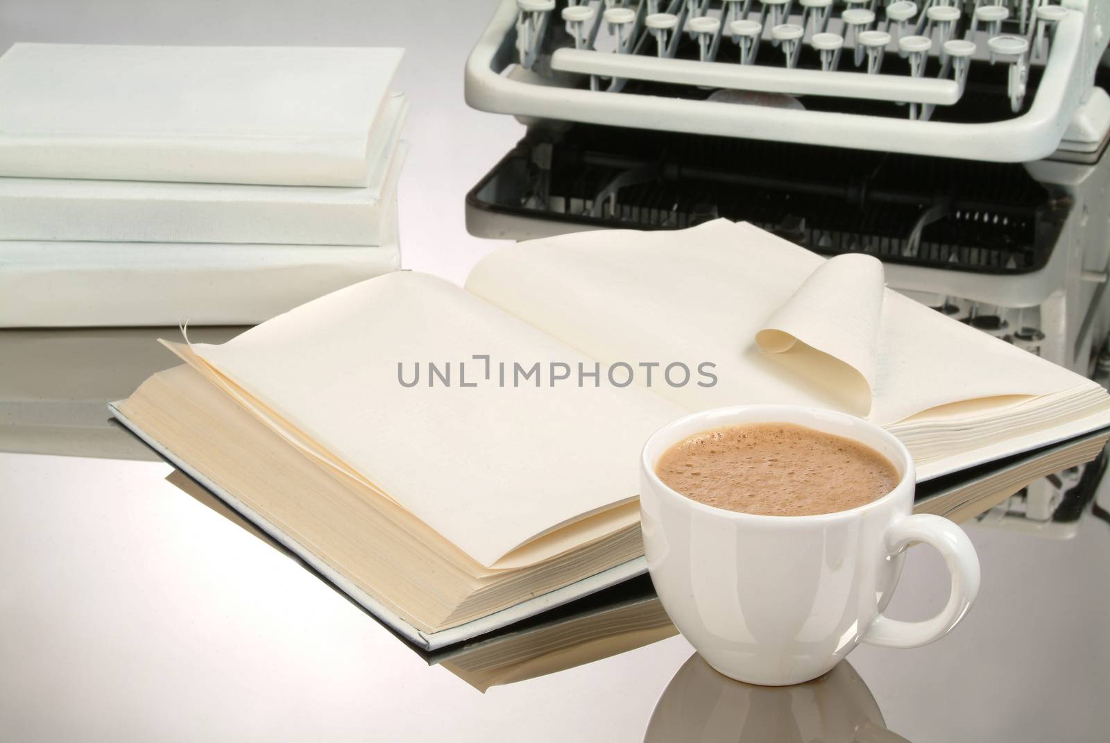 Cup of coffee an old typewriter on a glass background