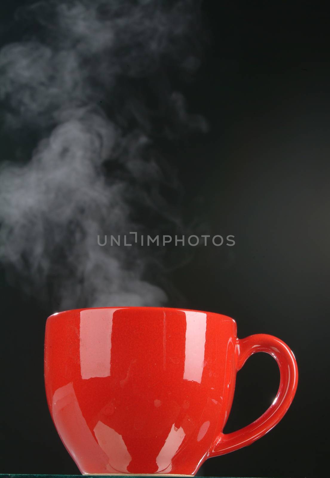 Red cup and smoke on a black background