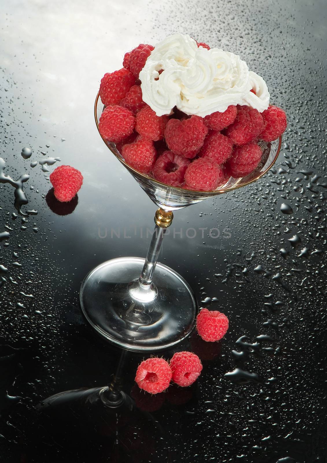 Glass with raspberries and cream