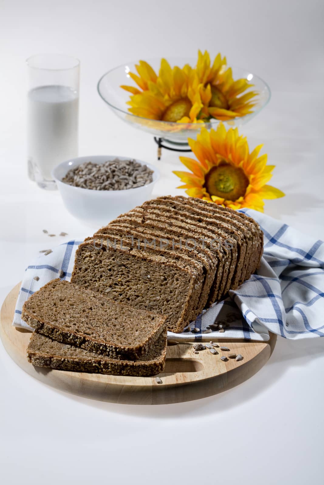 Pieces of bread, glass of milk and sunflower