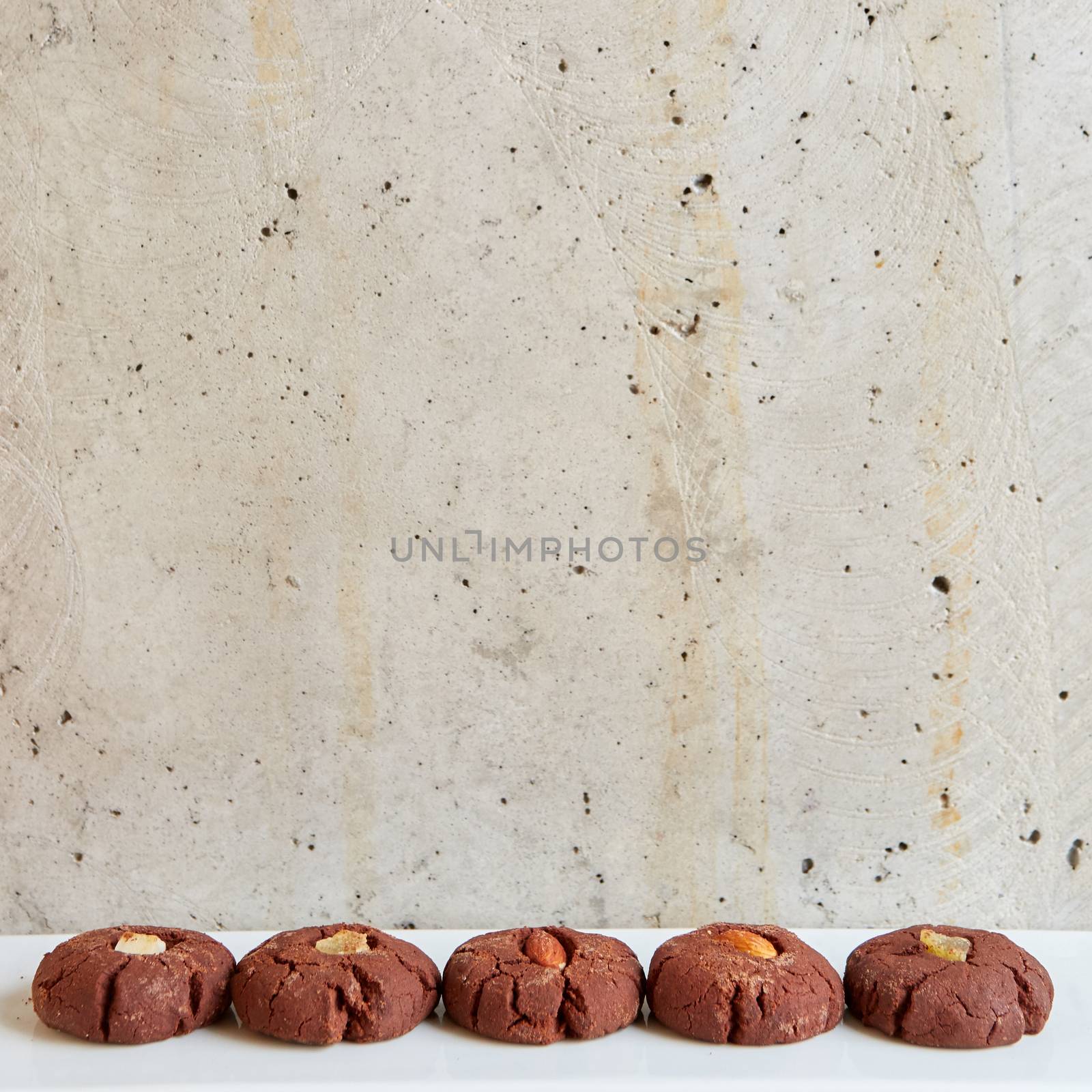 Chocolate cookies with nuts on gray background