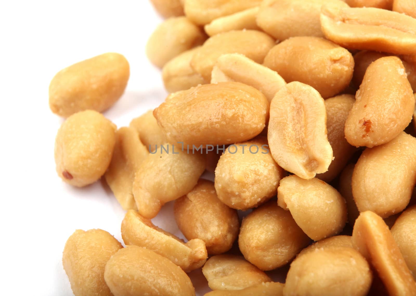 Close up of fried, peeled and salted peanuts.