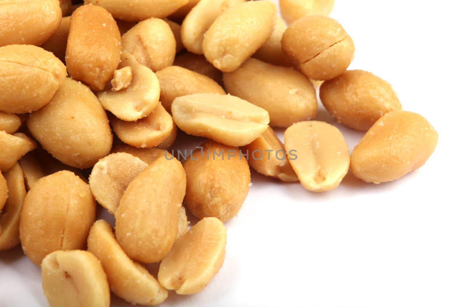 Close up of fried, peeled and salted peanuts.