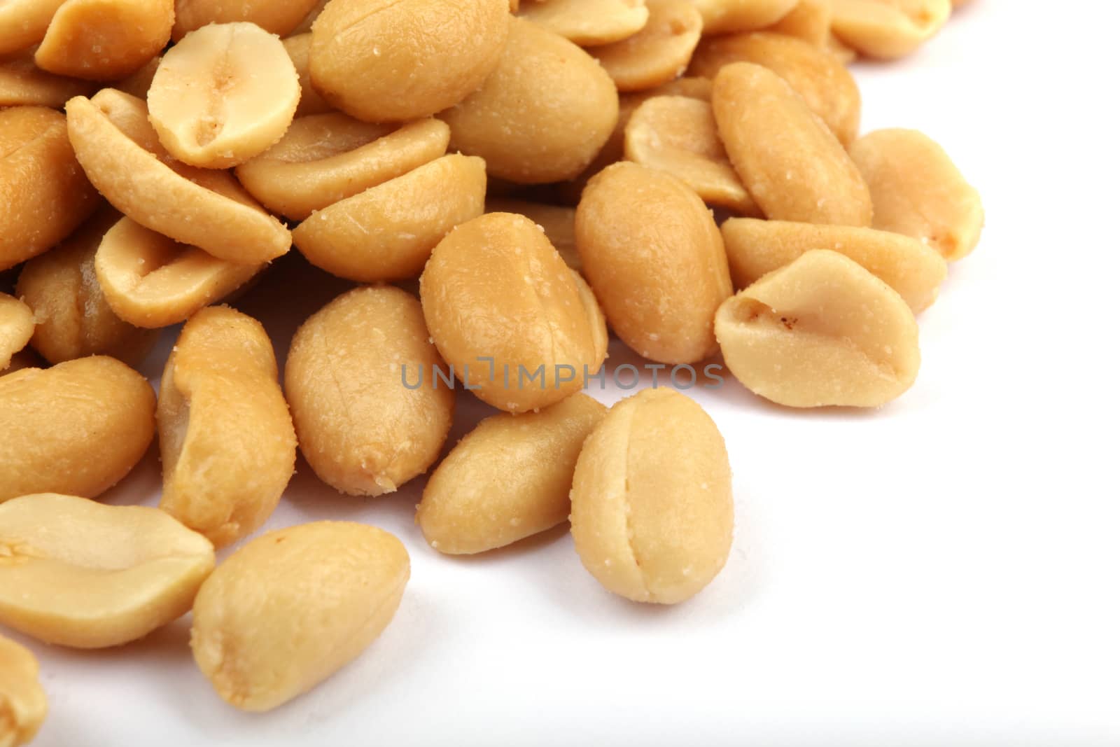 Close up of fried, peeled and salted peanuts.