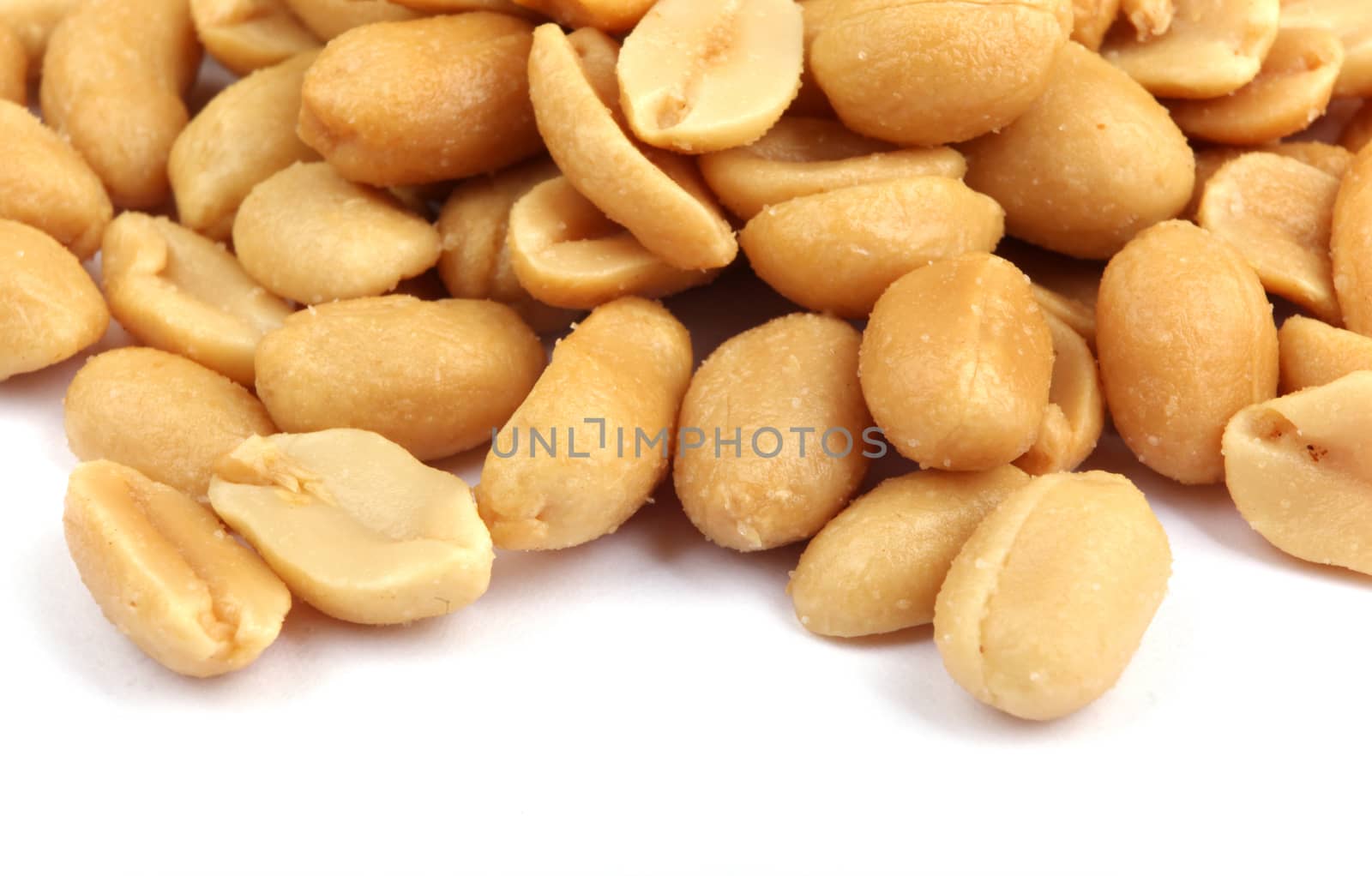 Close up of fried, peeled and salted peanuts.