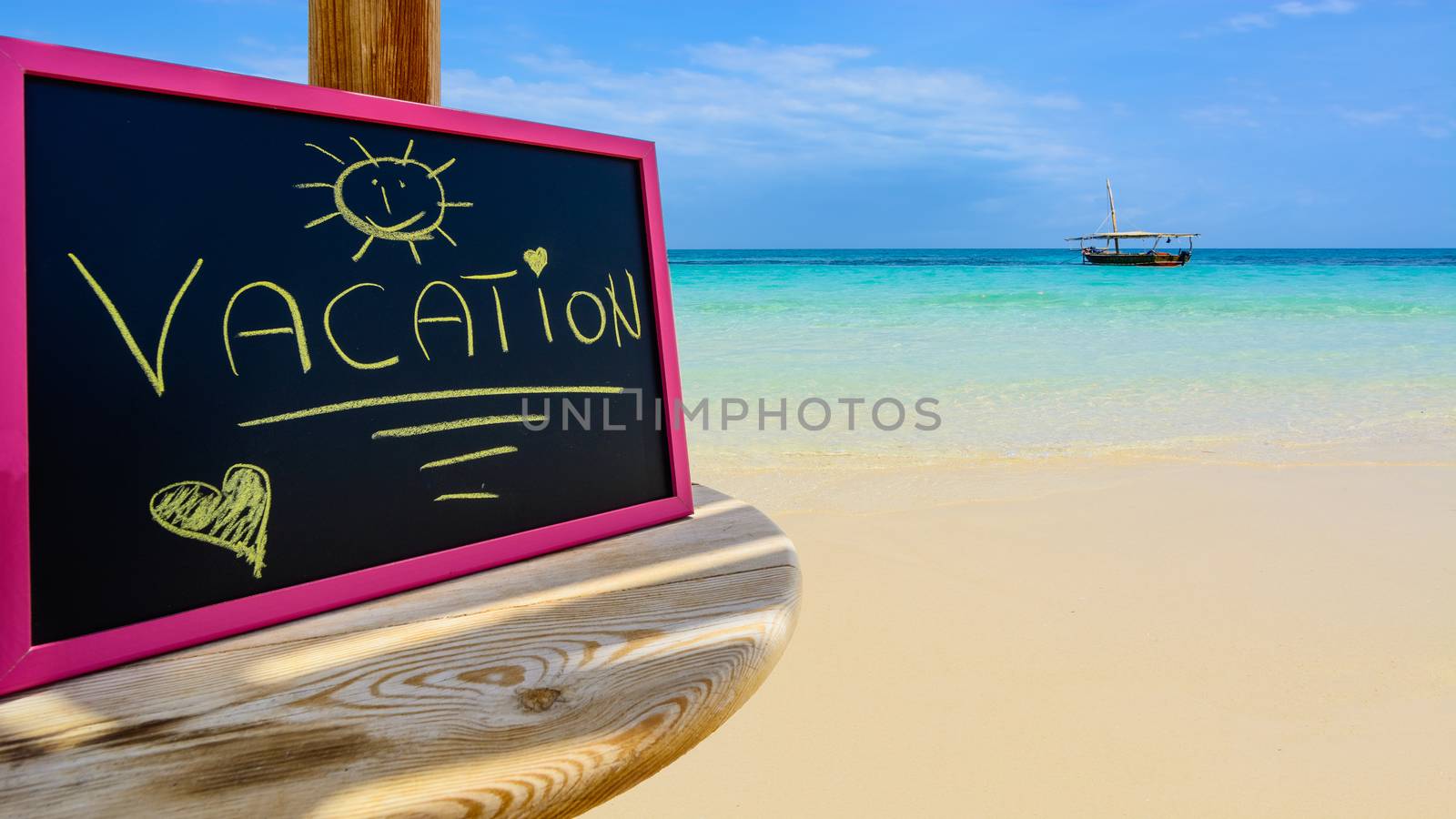 In the picture a Zanzibar beach which is a small blackboard with the words " Vacation" in the afternoon .